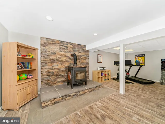 a view of swimming pool with lawn chairs and plants