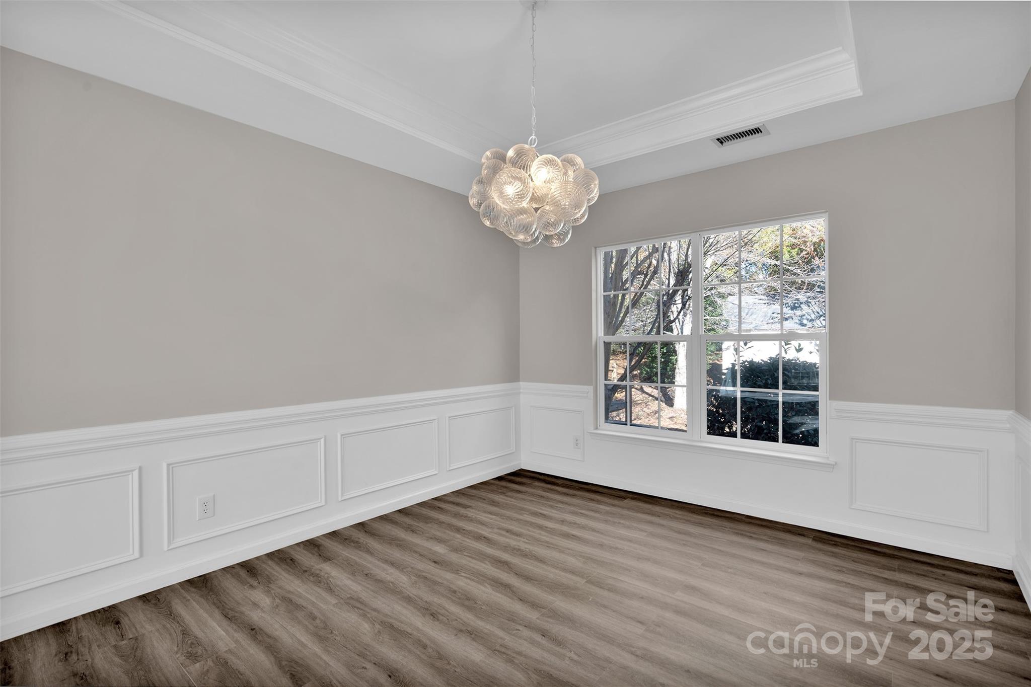 9211 Hickory Tree Lane Charlotte, NC 28277 - Photo 11 of 46 a view of an empty room with wooden floor and a window