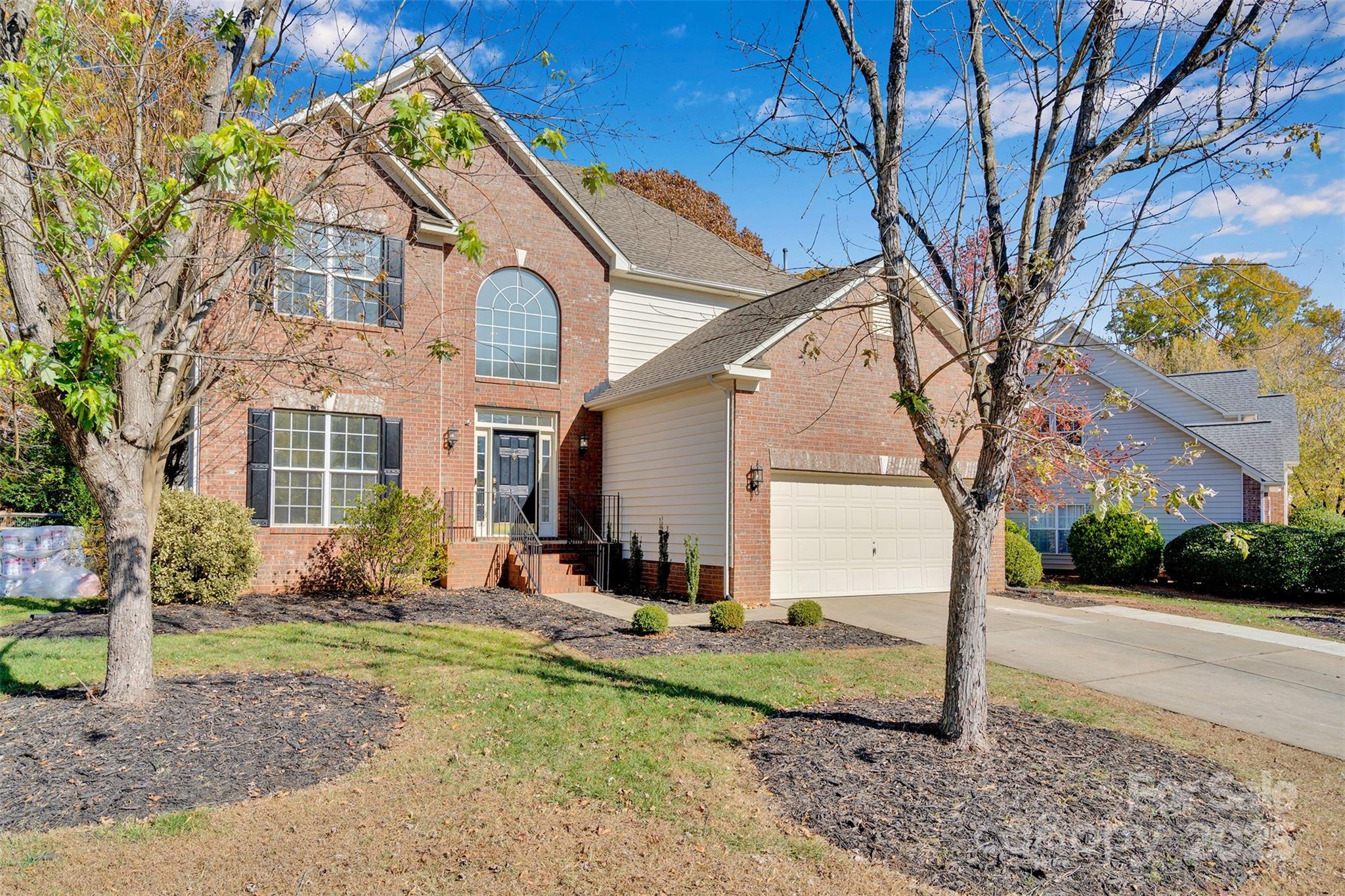 9211 Hickory Tree Lane Charlotte, NC 28277 - Photo 2 of 46 a front view of a house with garden