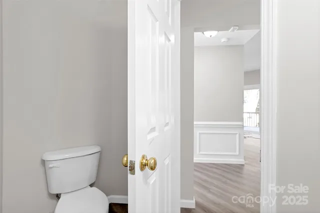 a white toilet sitting next to a bathroom sink