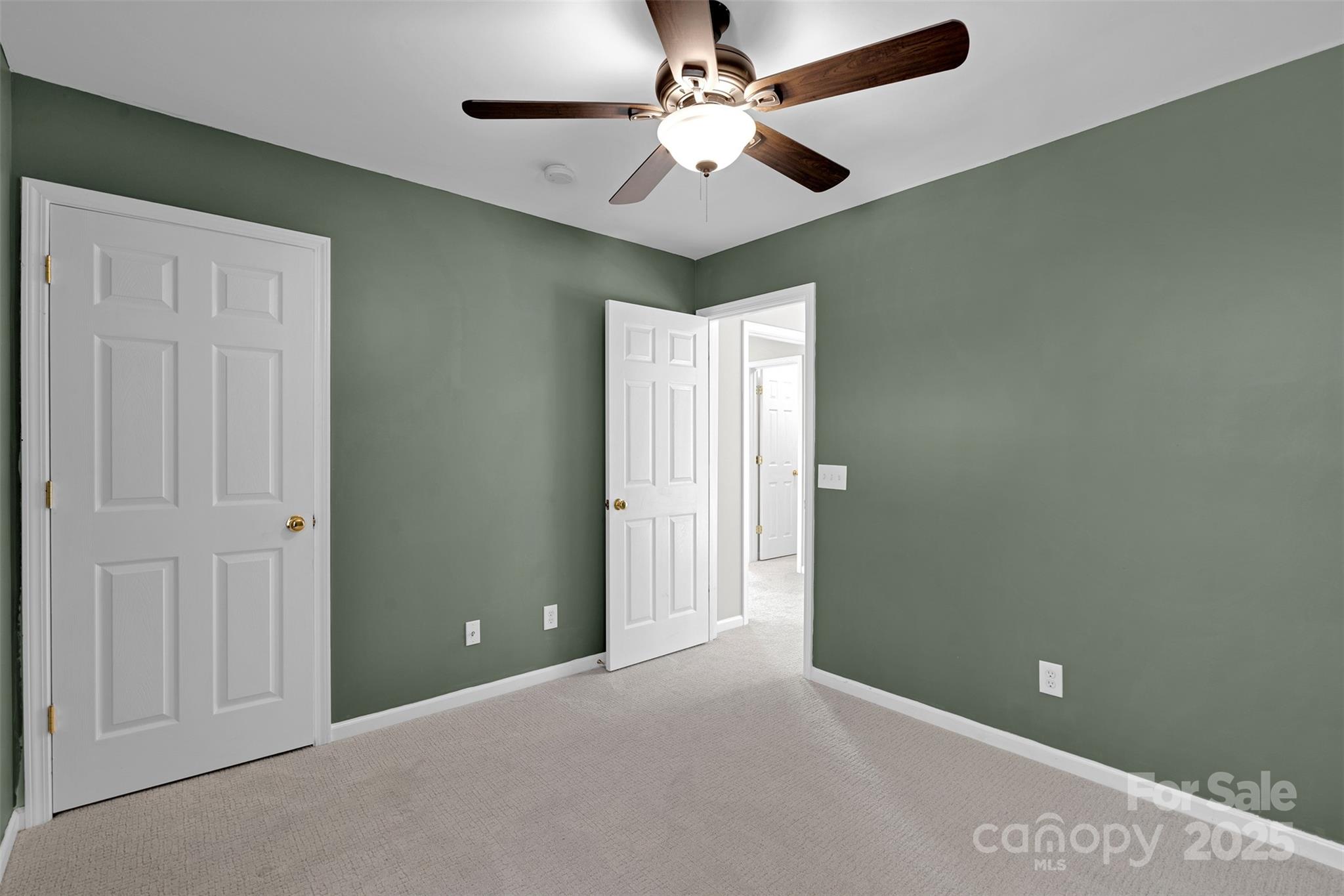 9211 Hickory Tree Lane Charlotte, NC 28277 - Photo 35 of 46 an empty room with closet and a ceiling fan