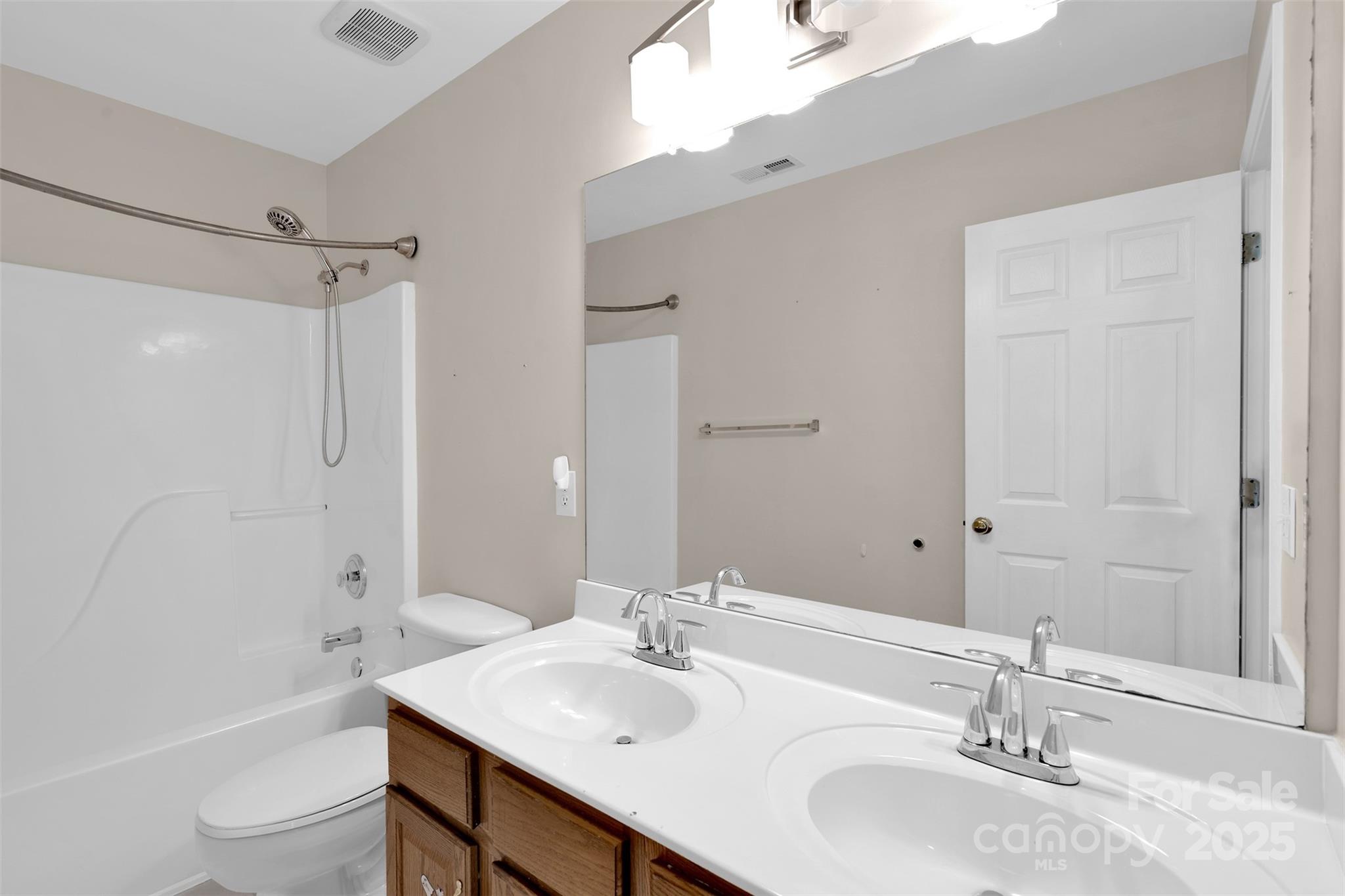 9211 Hickory Tree Lane Charlotte, NC 28277 - Photo 36 of 46 a bathroom with a granite countertop sink toilet and shower