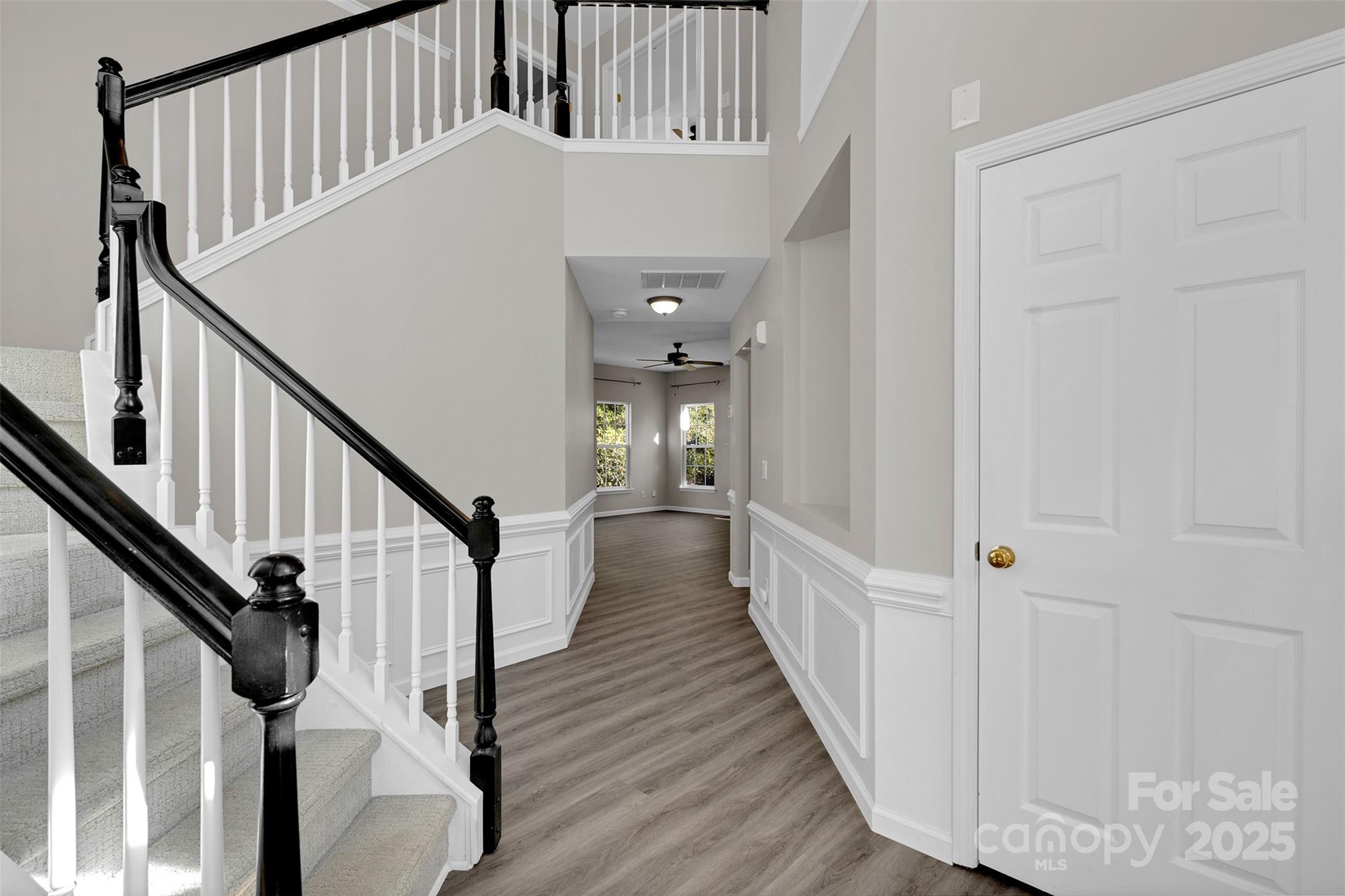 9211 Hickory Tree Lane Charlotte, NC 28277 - Photo 5 of 46 a view of staircase with wooden floor and fan