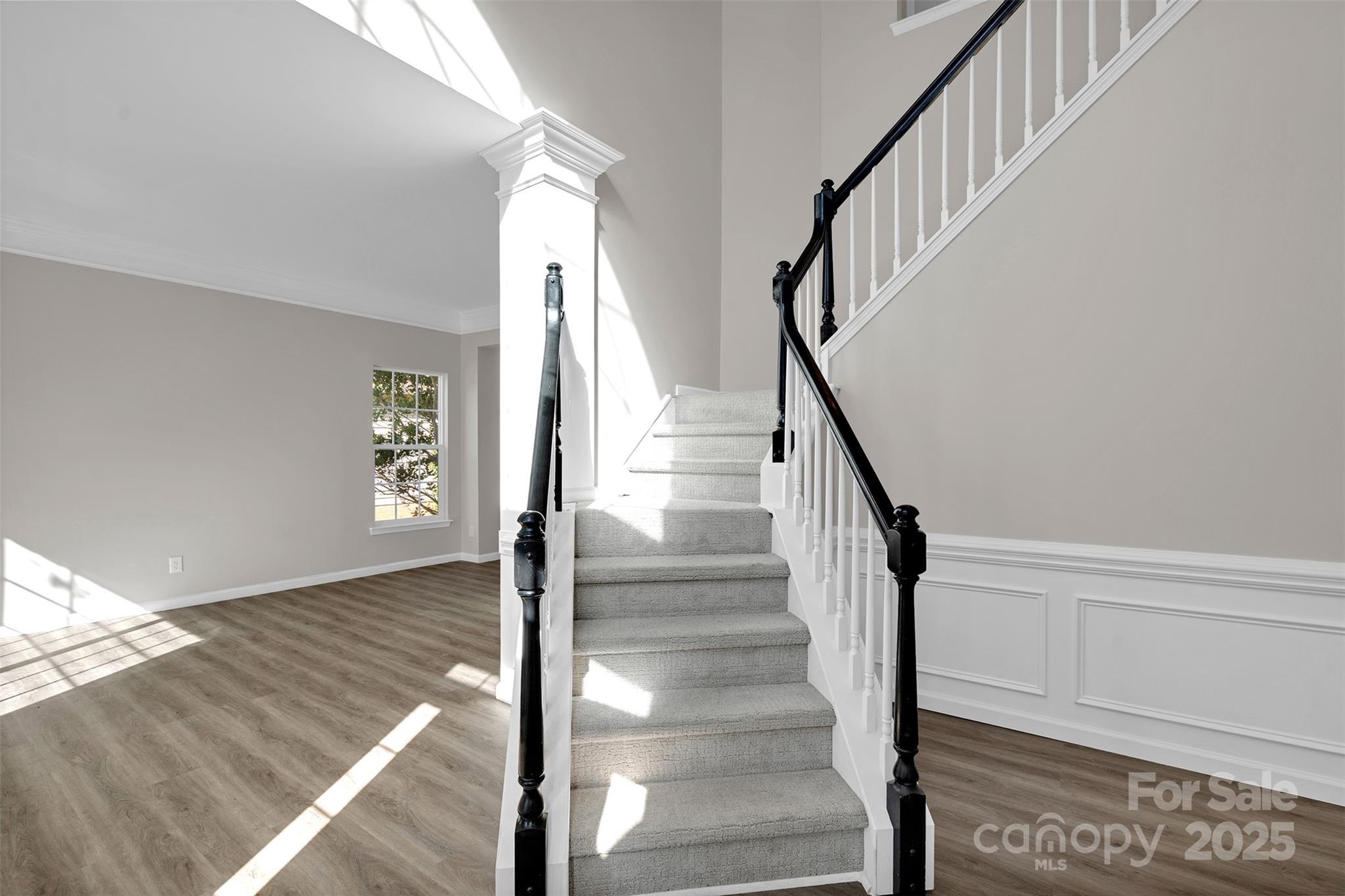 9211 Hickory Tree Lane Charlotte, NC 28277 - Photo 6 of 46 a view of staircase with wooden floor and a rug