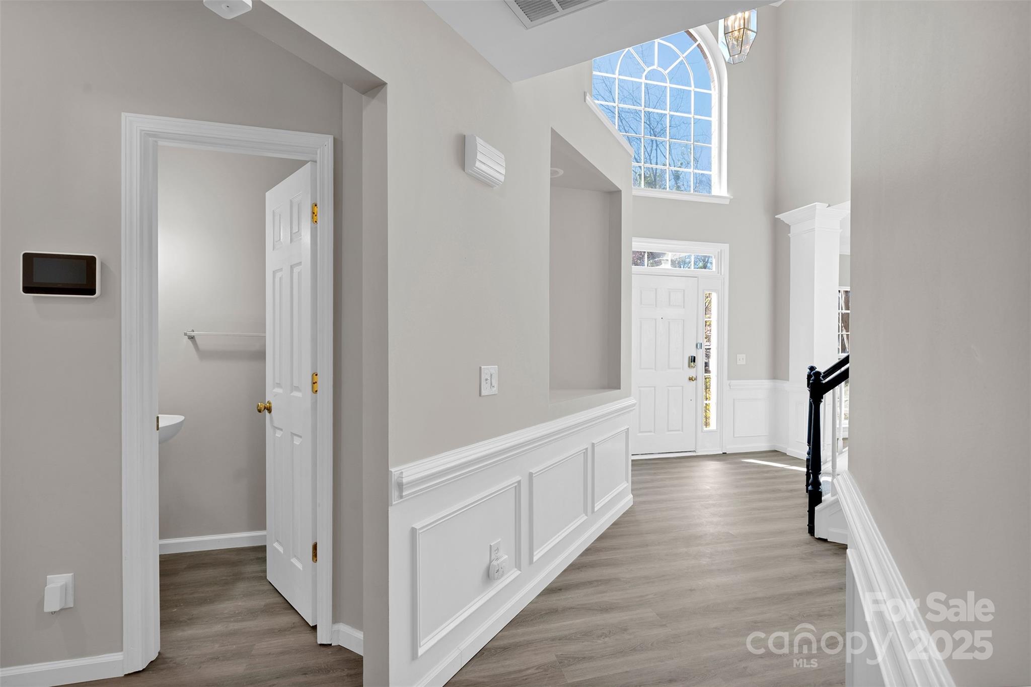 9211 Hickory Tree Lane Charlotte, NC 28277 - Photo 7 of 46 a view of a hallway with wooden floor and staircase
