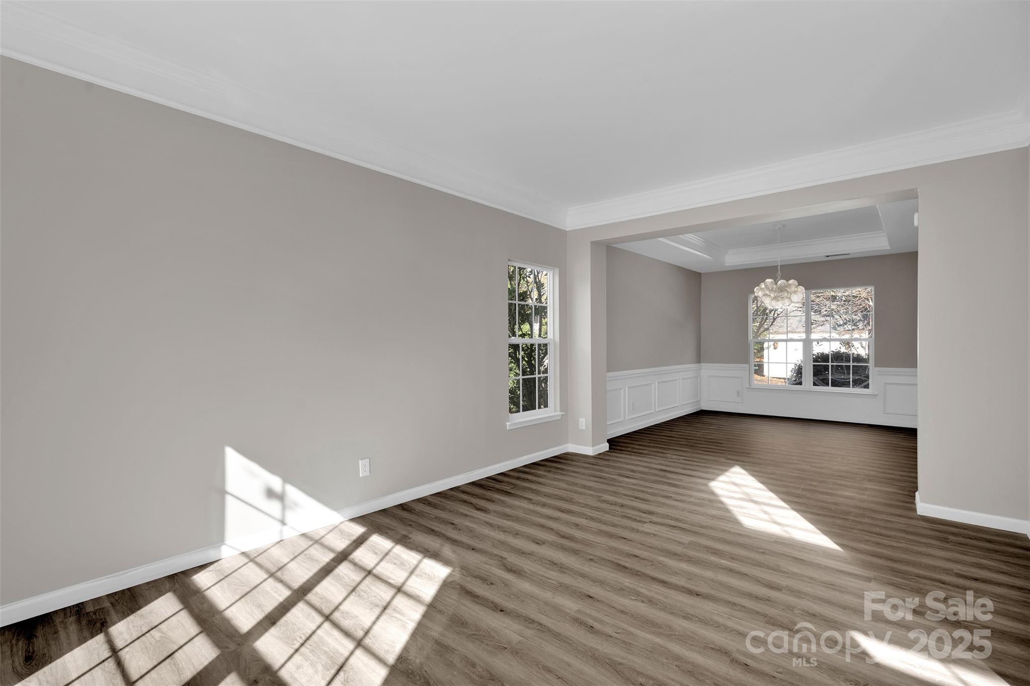 9211 Hickory Tree Lane Charlotte, NC 28277 - Photo 9 of 46 a view of an empty room with wooden floor and a window