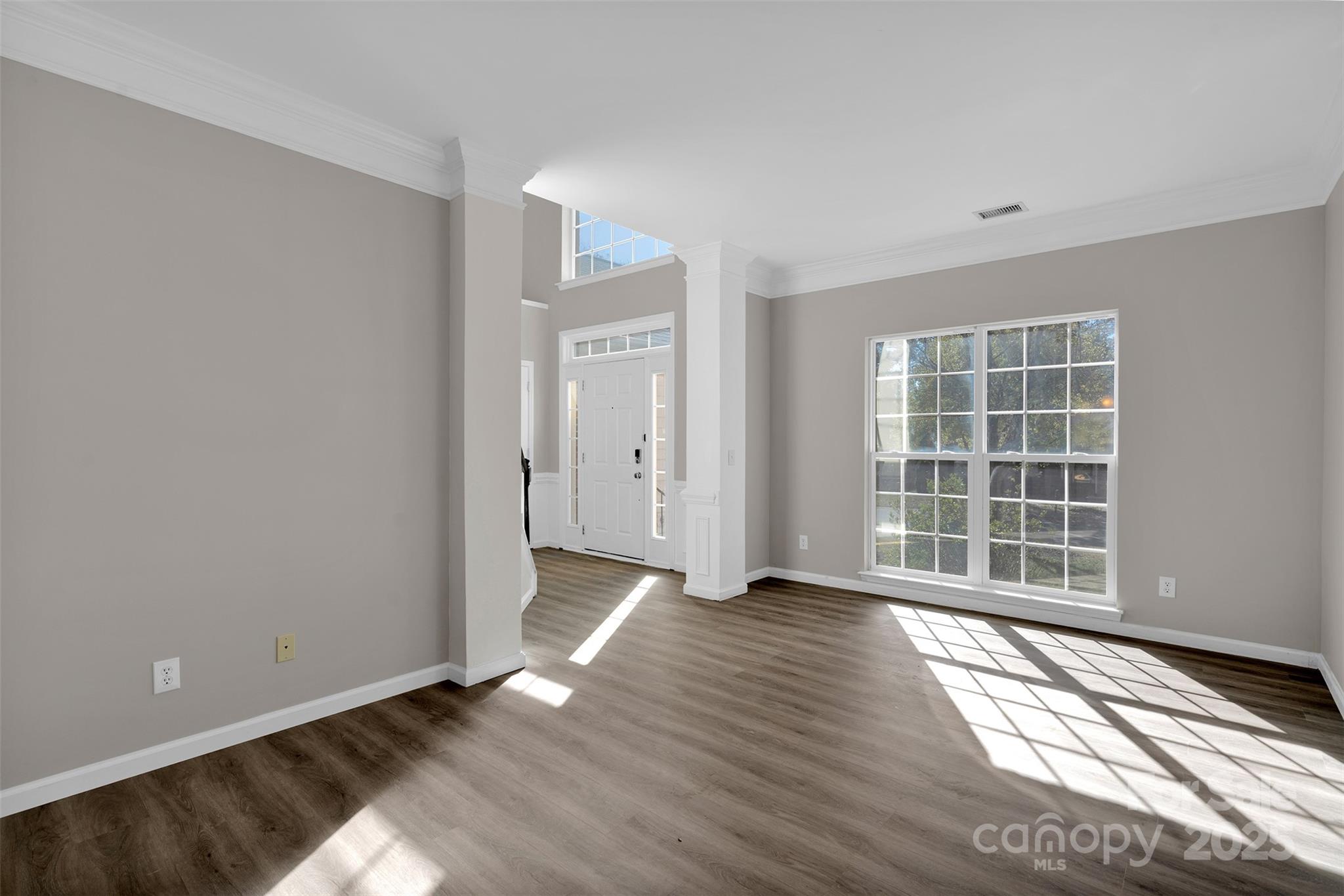 9211 Hickory Tree Lane Charlotte, NC 28277 - Photo 10 of 46 a view of an empty room with wooden floor and a window