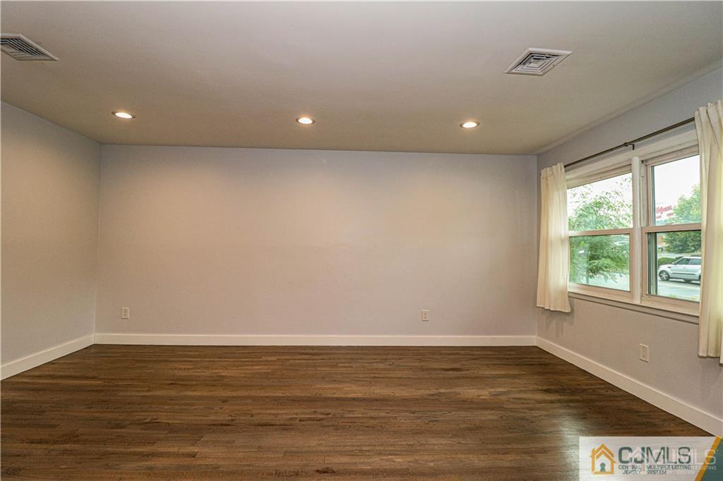 578 Chain O' Hills Road Colonia, NJ 07067 - Photo 11 of 39 a view of an empty room with wooden floor and a window
