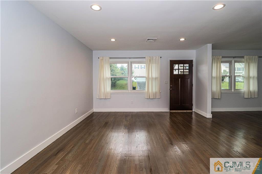578 Chain O' Hills Road Colonia, NJ 07067 - Photo 13 of 39 an empty room with wooden floor and windows