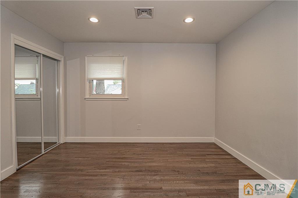 578 Chain O' Hills Road Colonia, NJ 07067 - Photo 15 of 39 a view of an empty room with wooden floor and a window