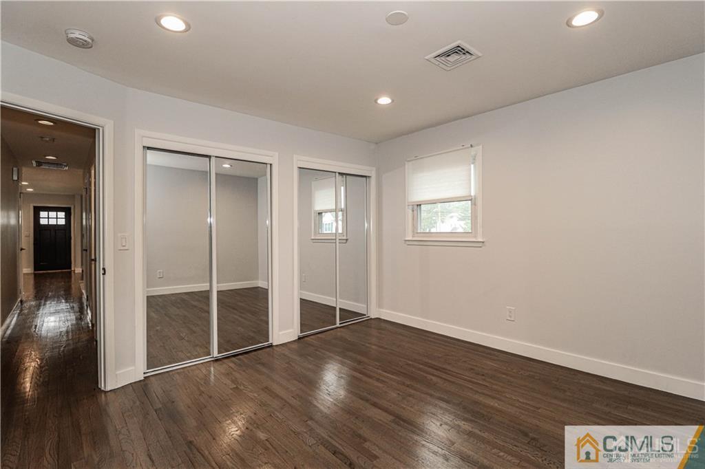578 Chain O' Hills Road Colonia, NJ 07067 - Photo 16 of 39 an empty room with wooden floor and windows
