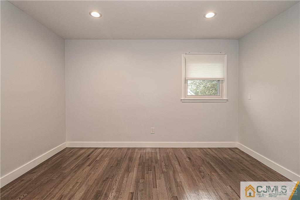 578 Chain O' Hills Road Colonia, NJ 07067 - Photo 17 of 39 wooden floor in an empty room with a window