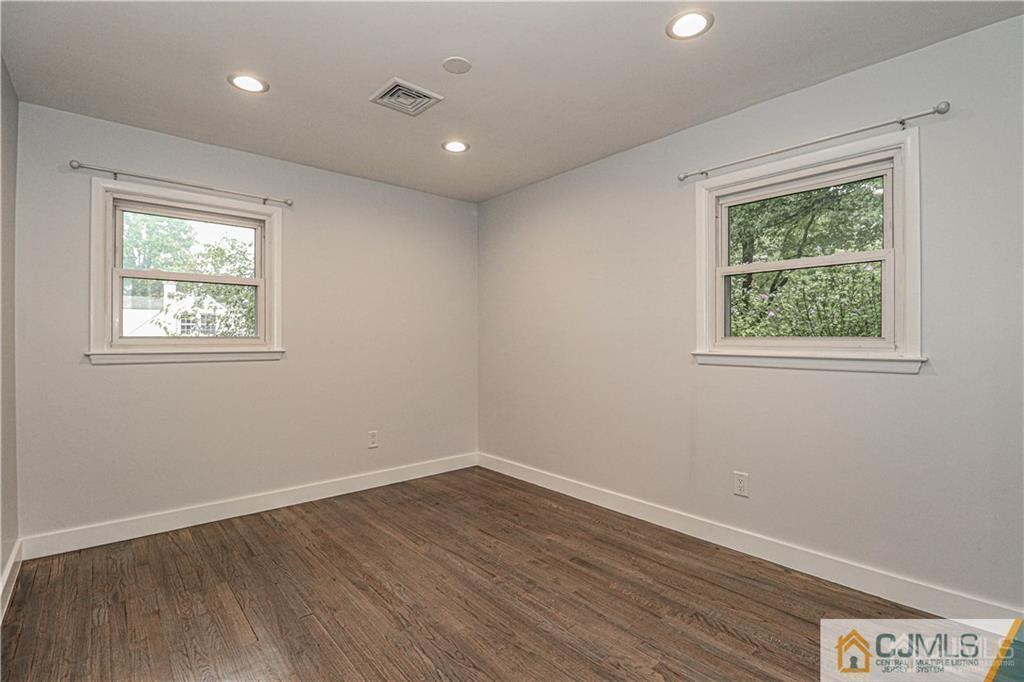 578 Chain O' Hills Road Colonia, NJ 07067 - Photo 18 of 39 wooden floor in an empty room with a window