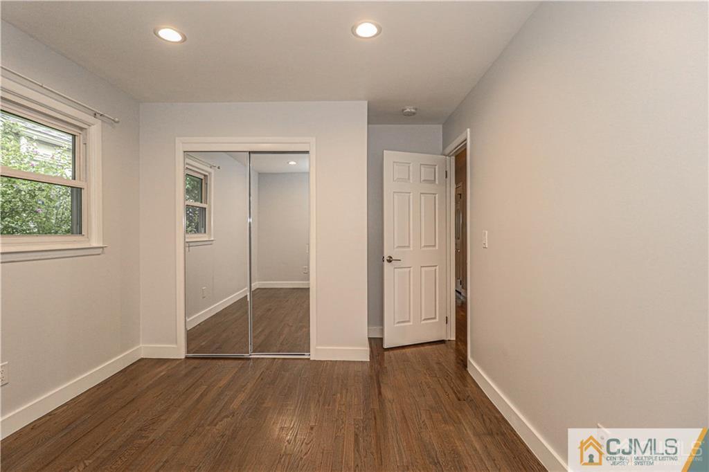 578 Chain O' Hills Road Colonia, NJ 07067 - Photo 19 of 39 an empty room with wooden floor and windows