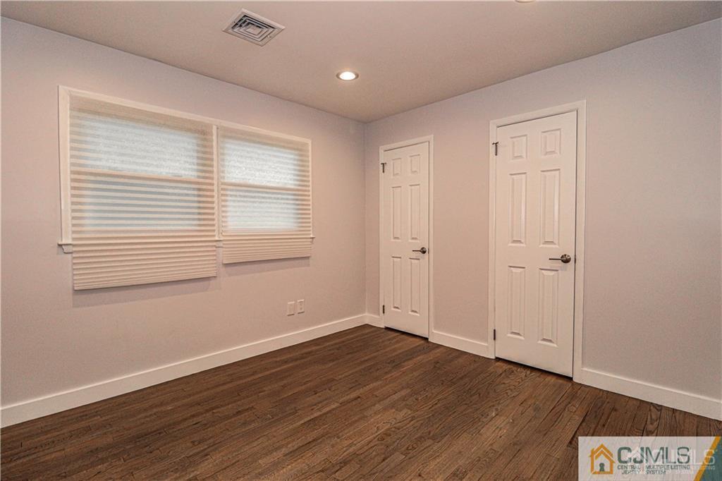 578 Chain O' Hills Road Colonia, NJ 07067 - Photo 20 of 39 a view of an empty room with wooden floor and a window