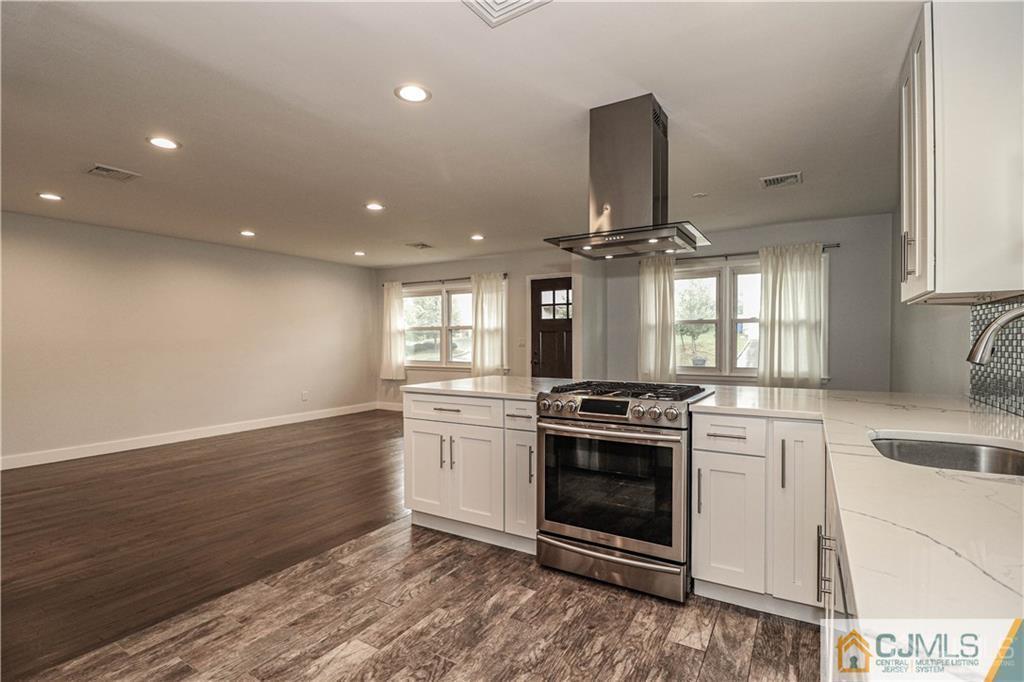 578 Chain O' Hills Road Colonia, NJ 07067 - Photo 2 of 39 a kitchen with stainless steel appliances granite countertop a stove and a sink