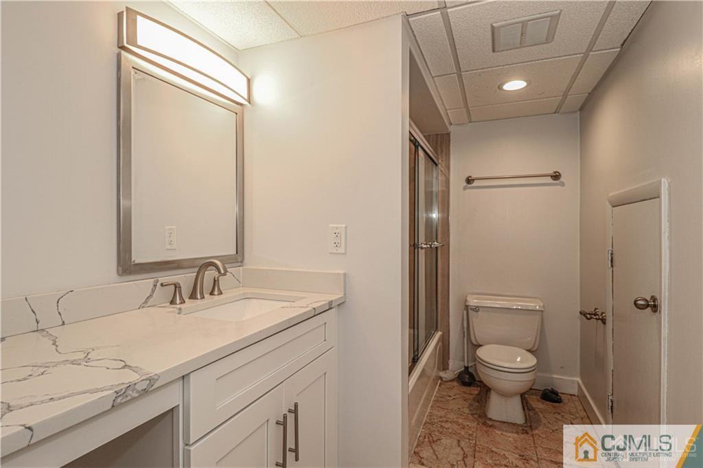 578 Chain O' Hills Road Colonia, NJ 07067 - Photo 25 of 39 a bathroom with a granite countertop sink toilet and shower
