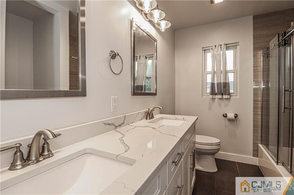 578 Chain O' Hills Road Colonia, NJ 07067 - Photo 27 of 39 a bathroom with a sink and a mirror