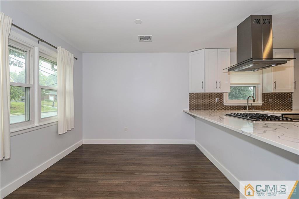 578 Chain O' Hills Road Colonia, NJ 07067 - Photo 6 of 39 a kitchen with stainless steel appliances a sink stove and wooden floor