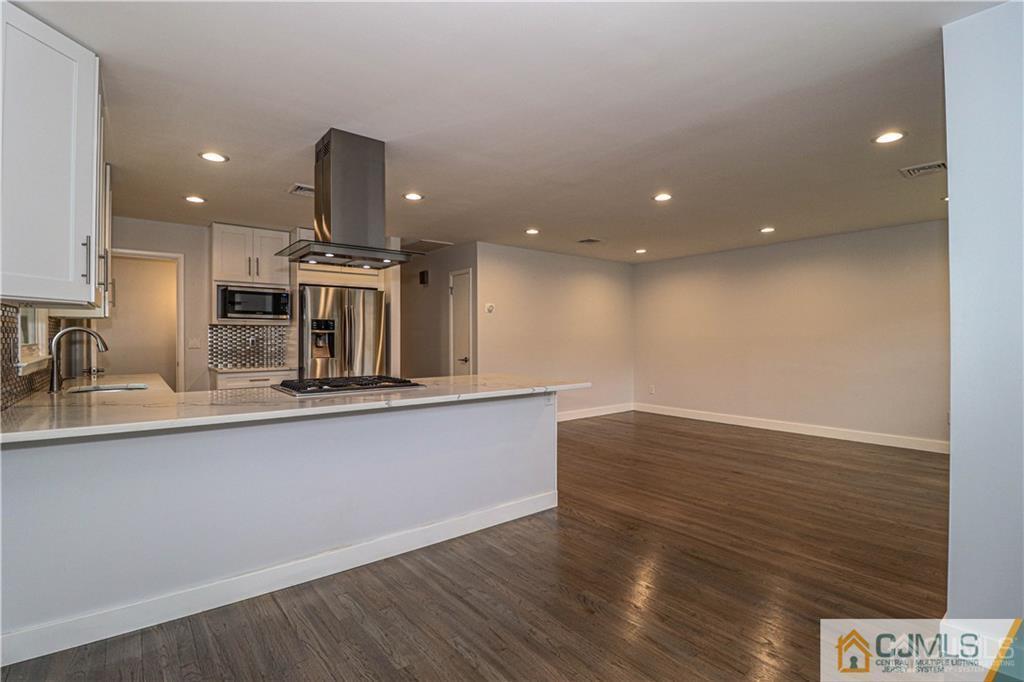 578 Chain O' Hills Road Colonia, NJ 07067 - Photo 7 of 39 a view of kitchen with stainless steel appliances sinks and wooden floor