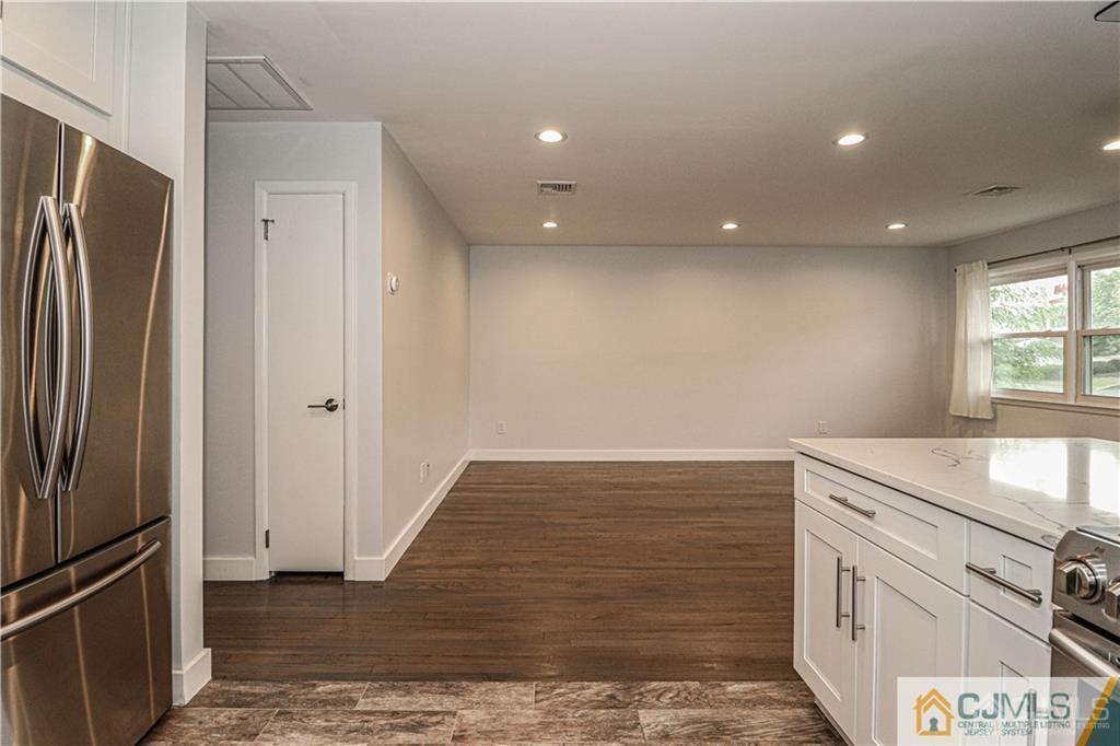 578 Chain O' Hills Road Colonia, NJ 07067 - Photo 10 of 39 a view of kitchen with refrigerator stove and wooden floor