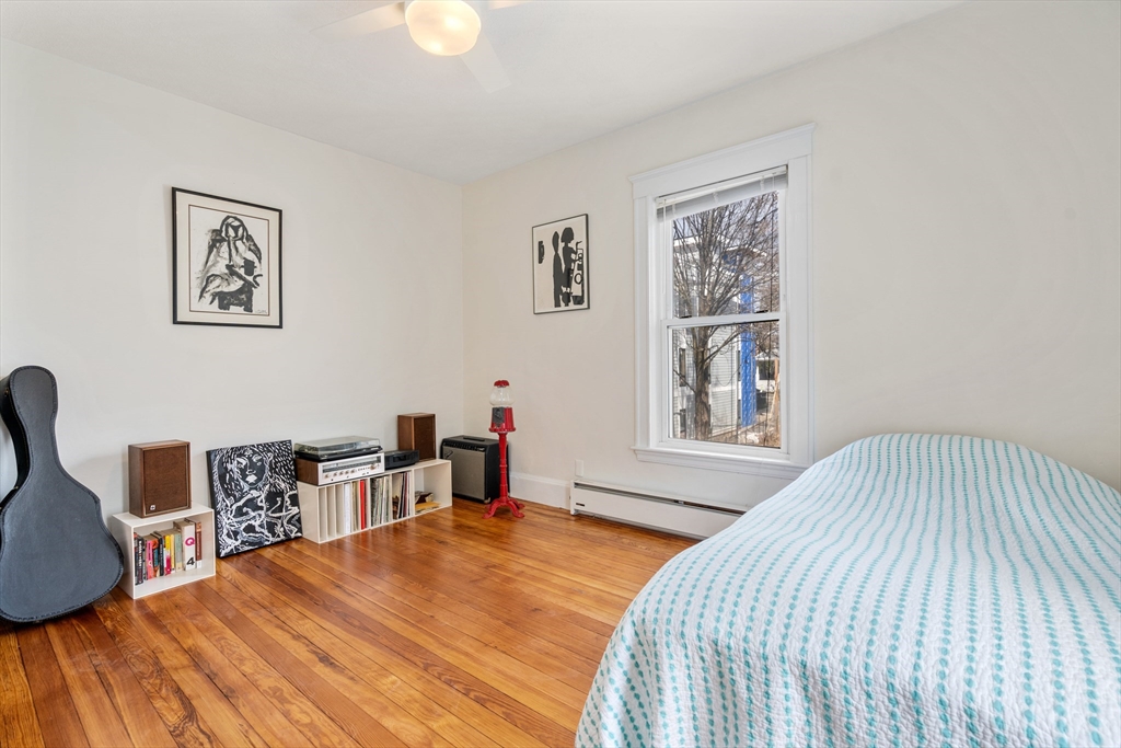 75 Brook Street, Unit 1 Brookline, MA 02445 - Photo 14 of 26 a bedroom with a bed and a table in it
