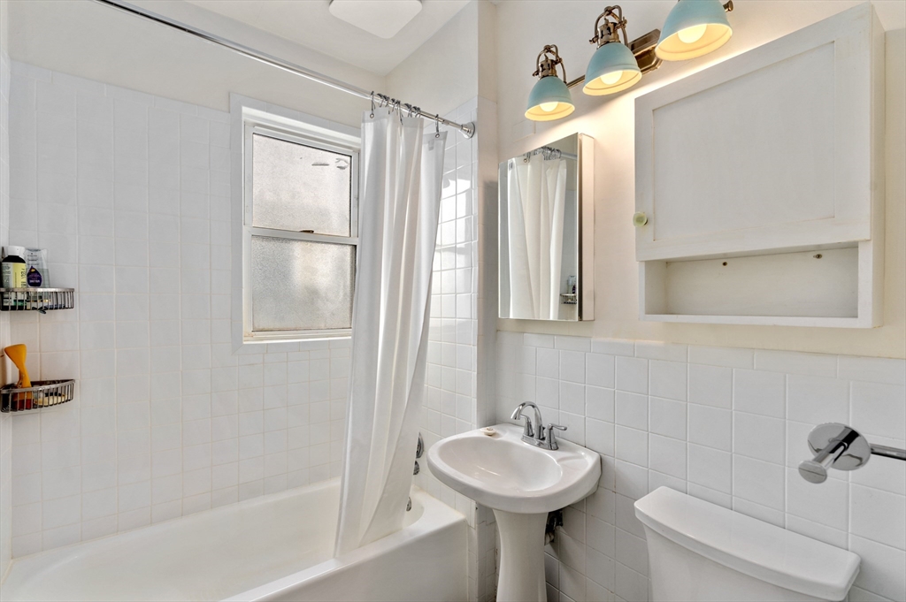 75 Brook Street, Unit 1 Brookline, MA 02445 - Photo 15 of 26 a bathroom with a sink mirror toilet and bathtub