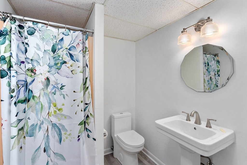 75 Brook Street, Unit 1 Brookline, MA 02445 - Photo 16 of 26 a bathroom with a sink toilet and a mirror