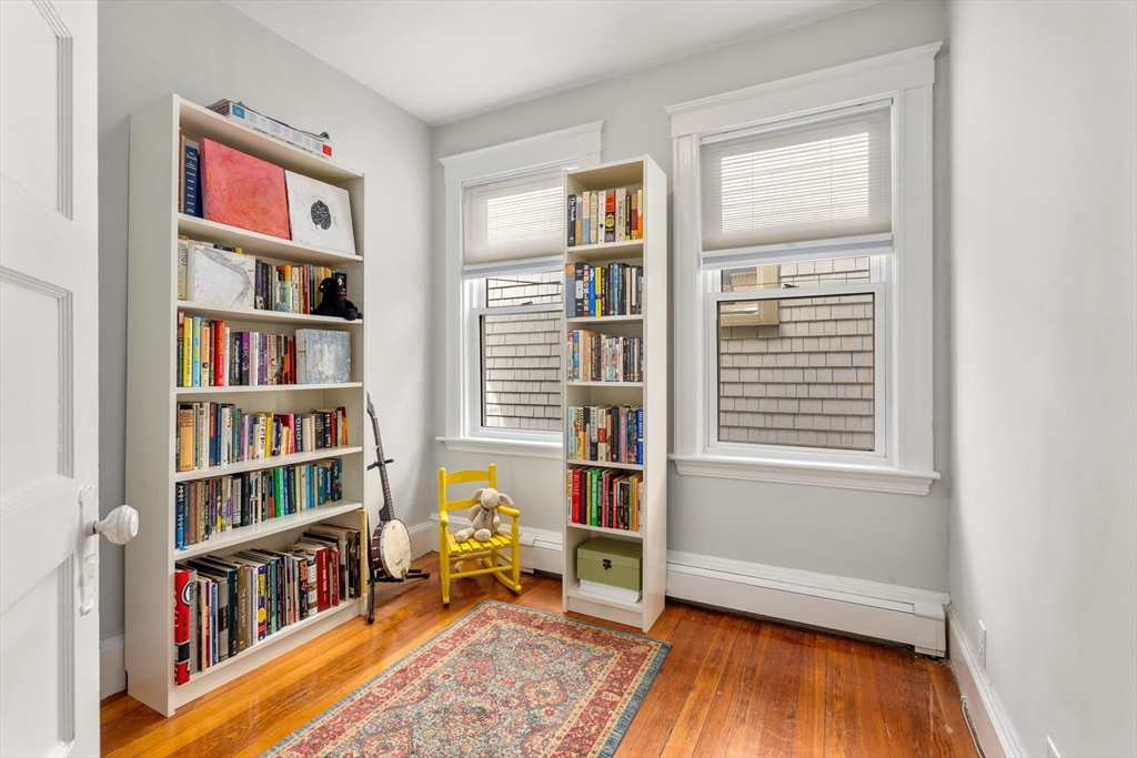 75 Brook Street, Unit 1 Brookline, MA 02445 - Photo 17 of 26 a livingroom with a book shelf and a window