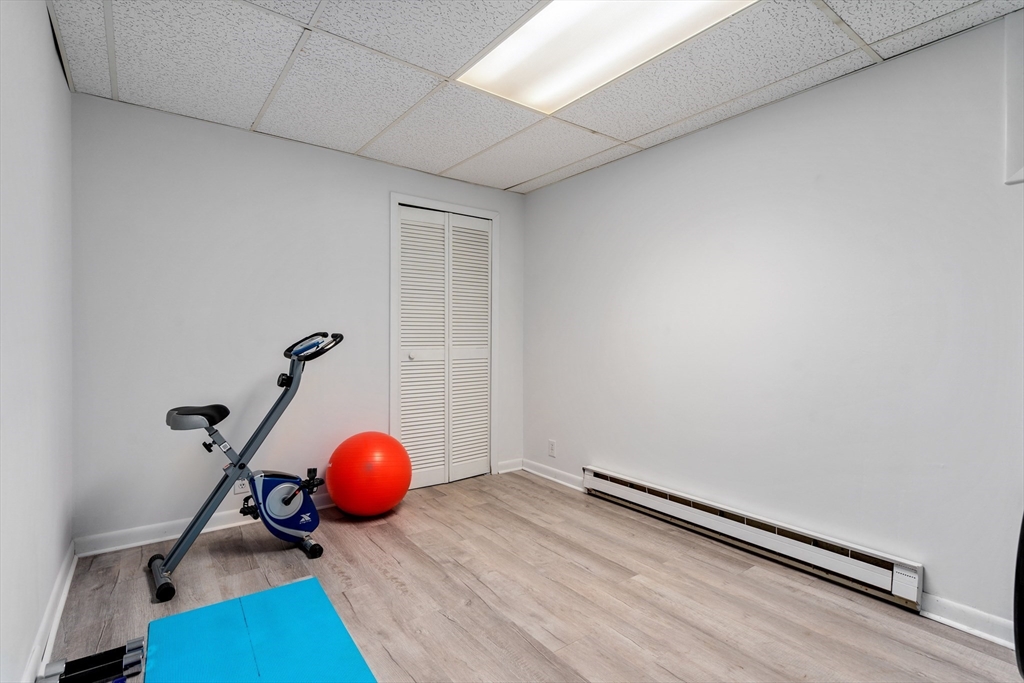 75 Brook Street, Unit 1 Brookline, MA 02445 - Photo 19 of 26 a room with wooden floor