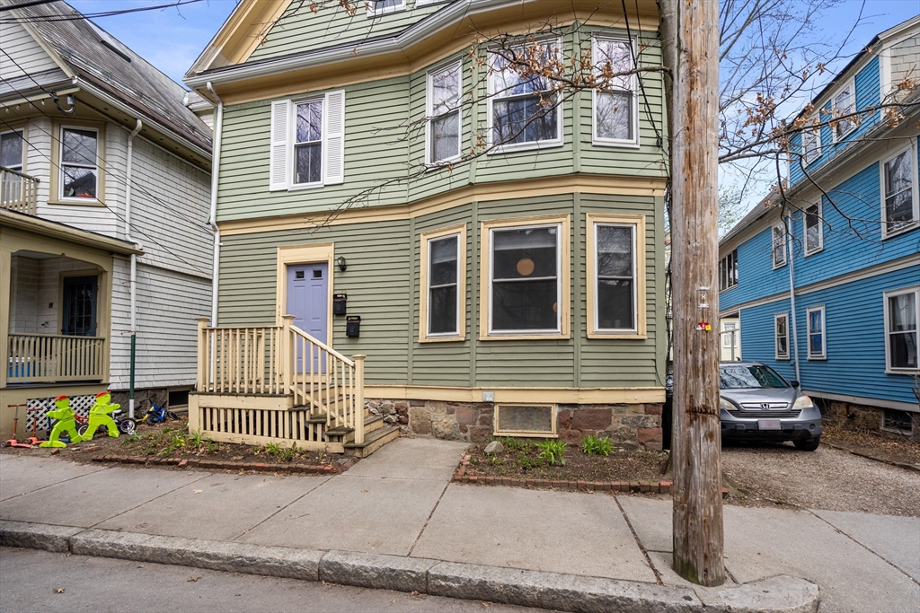 75 Brook Street, Unit 1 Brookline, MA 02445 - Photo 24 of 26 a front view of a house with a garden and plants