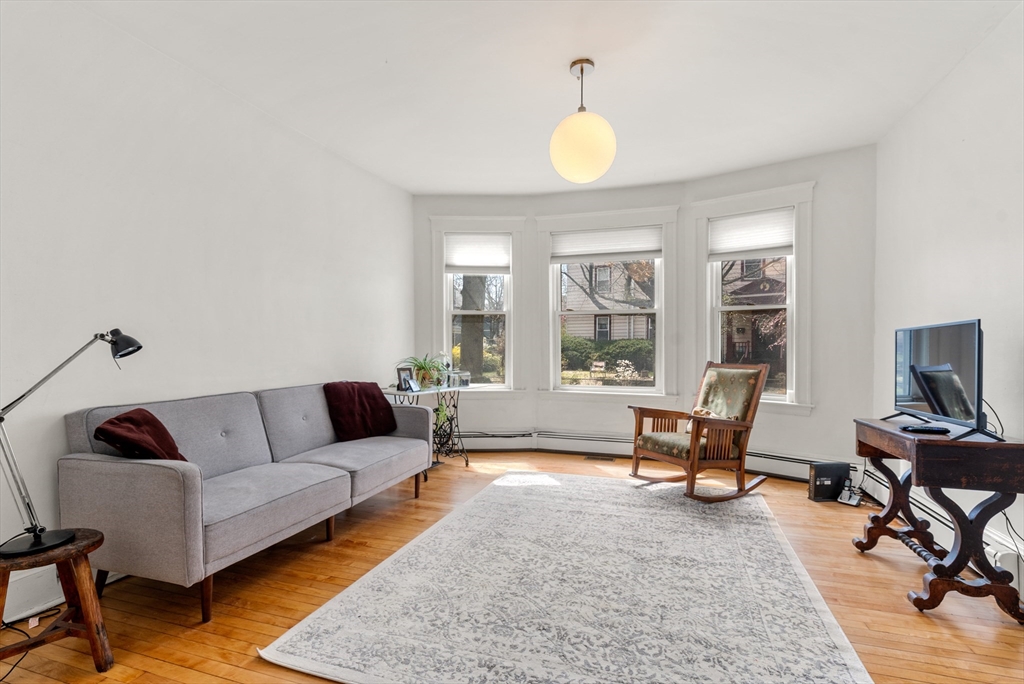 75 Brook Street, Unit 1 Brookline, MA 02445 - Photo 4 of 26 a living room with furniture and a flat screen tv