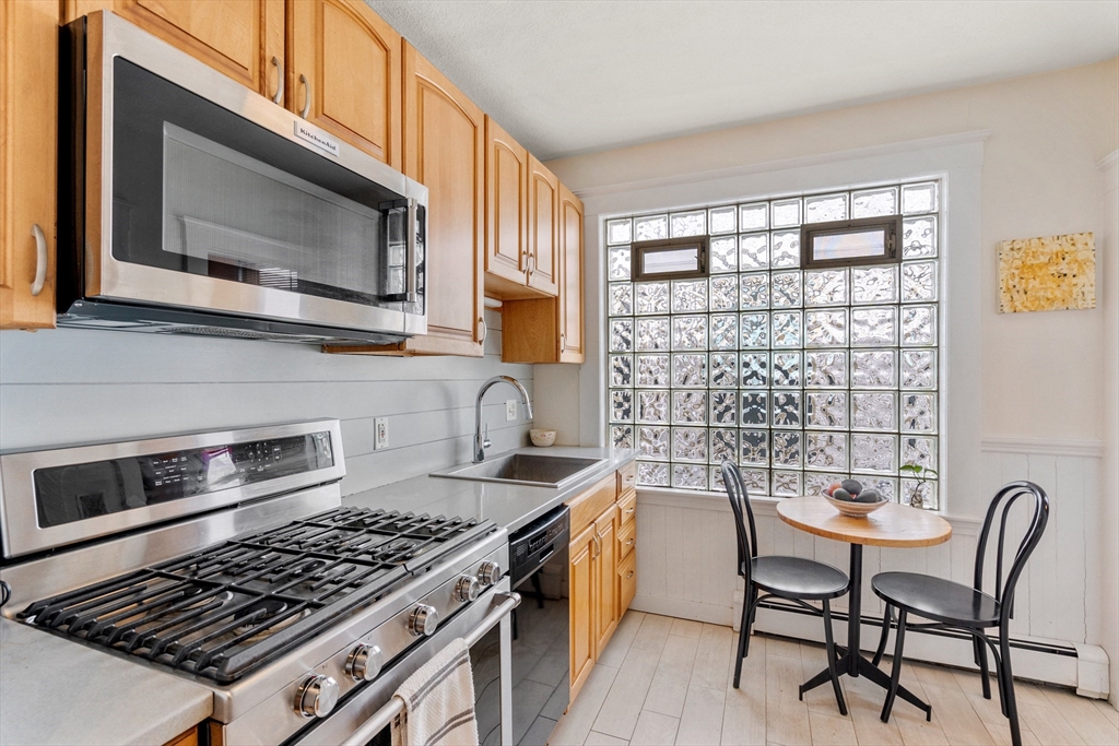 75 Brook Street, Unit 1 Brookline, MA 02445 - Photo 10 of 26 a kitchen with a stove a sink and a microwave