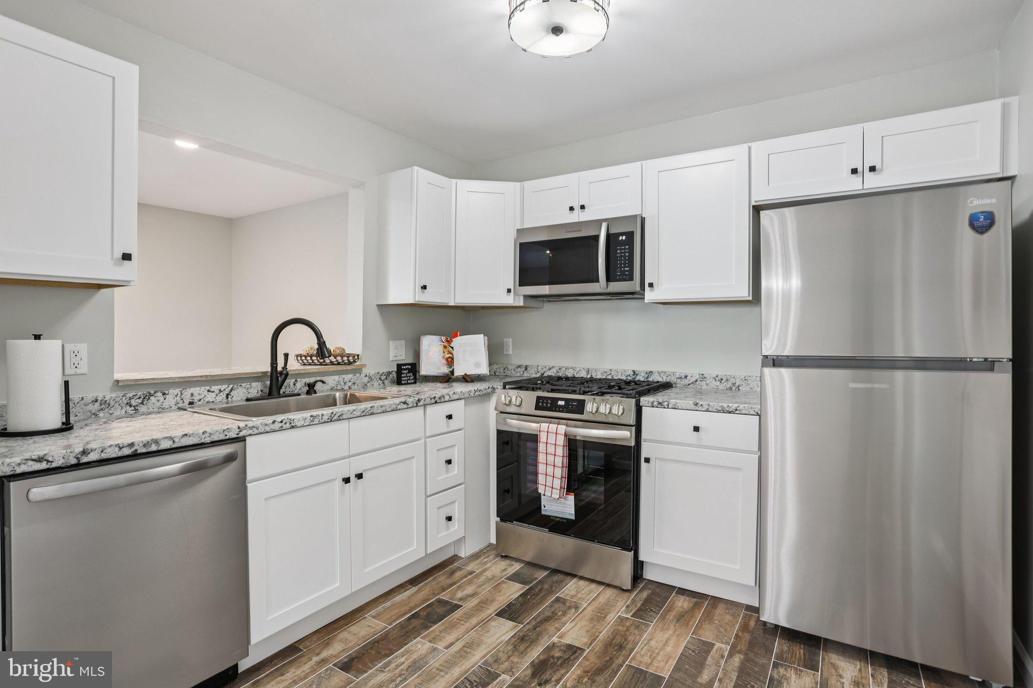 110 Auckland Drive Newark, DE 19702 - Photo 13 of 30 a kitchen with stainless steel appliances granite countertop a refrigerator sink and stove