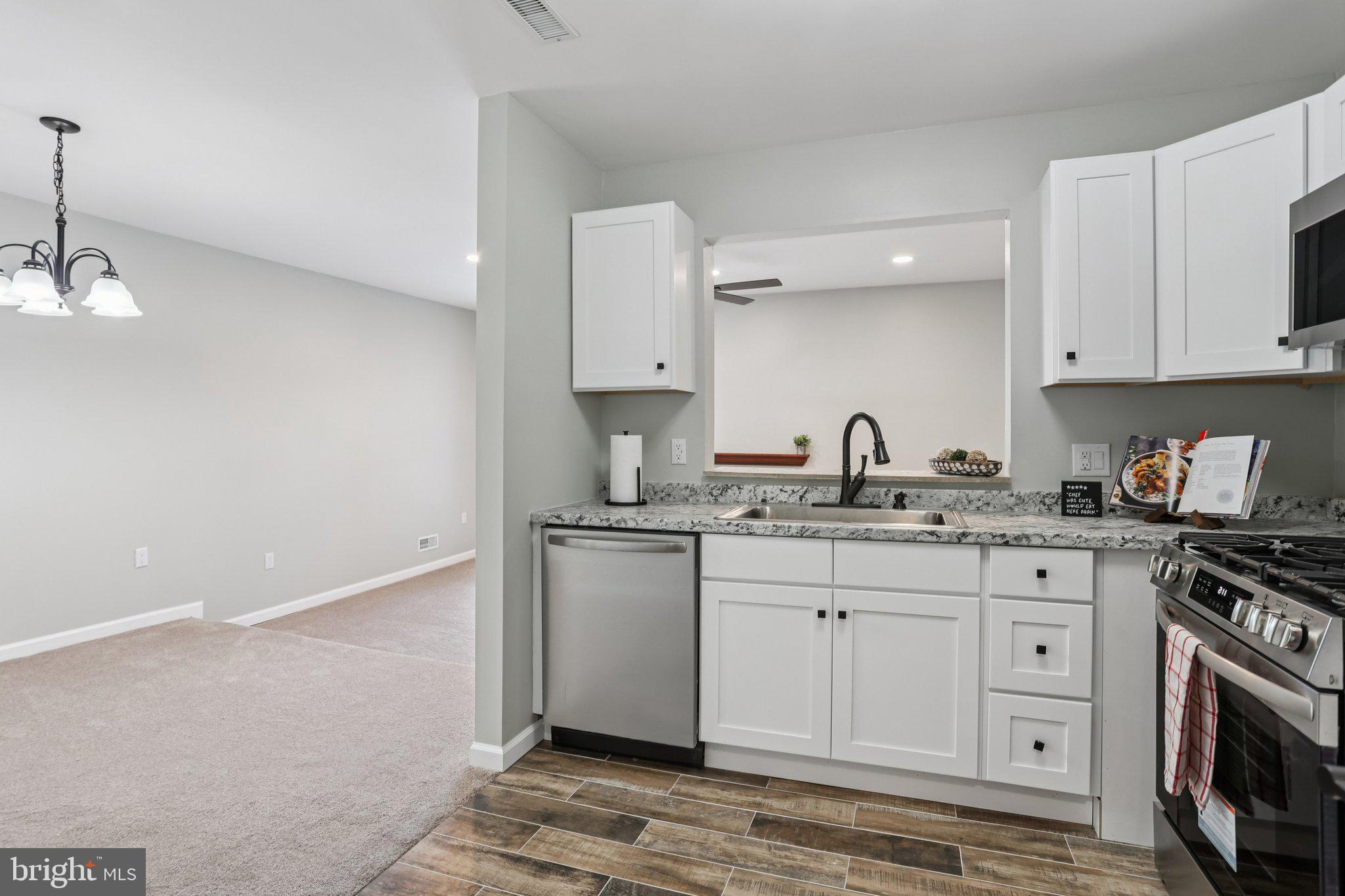 110 Auckland Drive Newark, DE 19702 - Photo 14 of 30 a kitchen with stainless steel appliances granite countertop a sink stove and cabinets