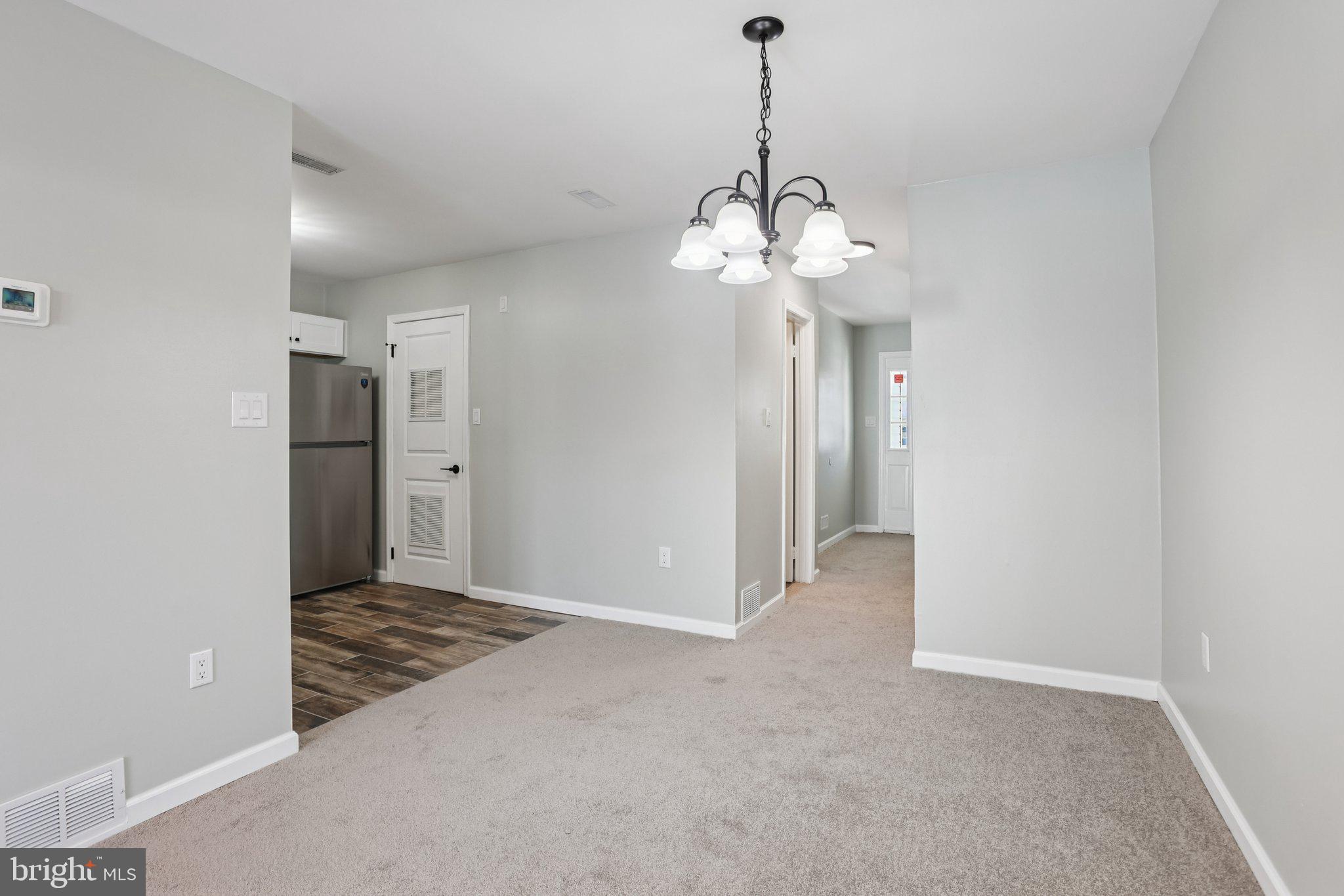 110 Auckland Drive Newark, DE 19702 - Photo 8 of 30 a view of a hallway with a chandelier