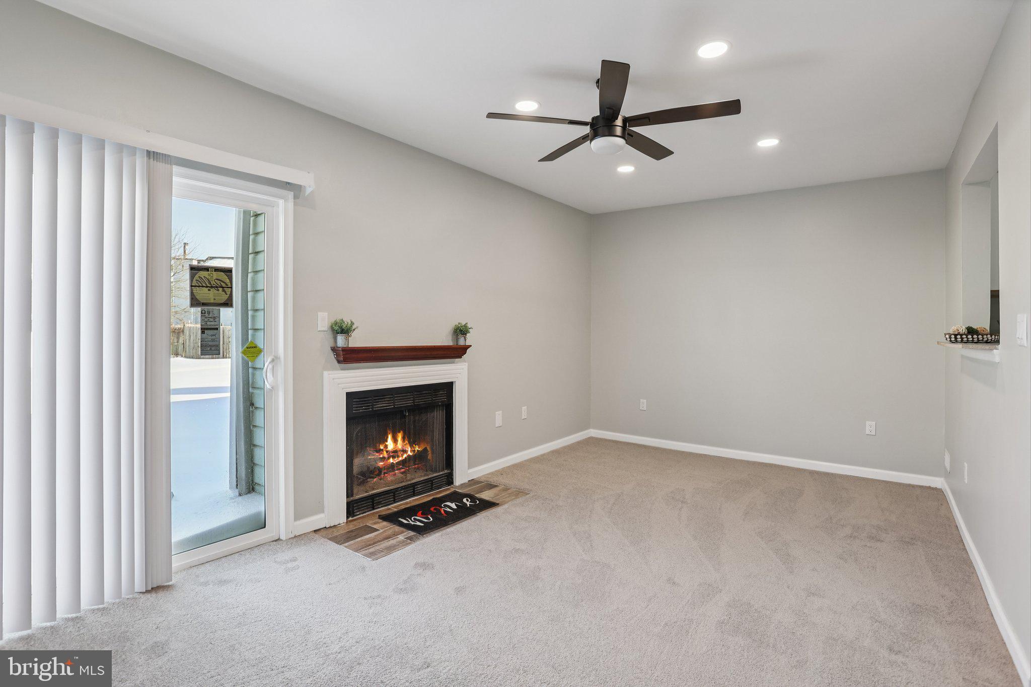 110 Auckland Drive Newark, DE 19702 - Photo 9 of 30 an empty room with fireplace and fan