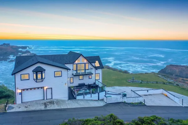 an aerial view of a house with a yard basket ball court and outdoor seating