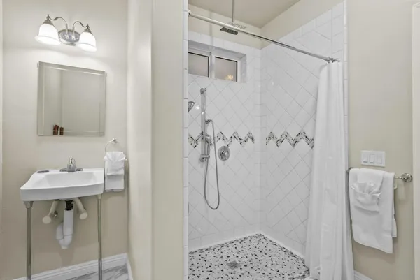 a bathroom with a sink toilet and shower