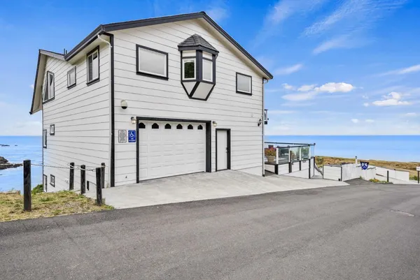 a front view of a house with a ocean view