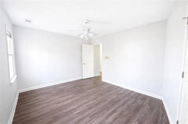 a view of an empty room with wooden floor