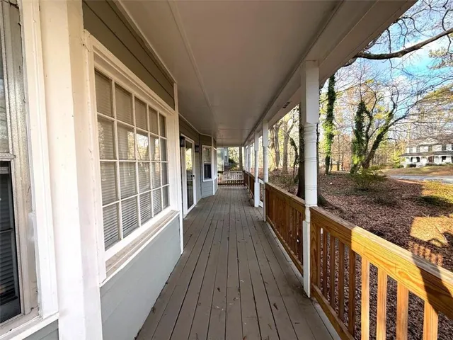 a view of a balcony with wooden floor