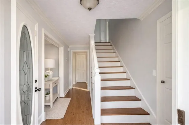 a view of a hallway with windows and stairs