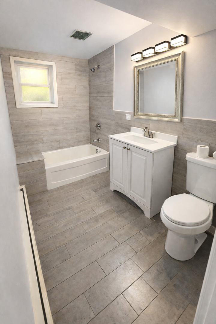 5518 West Melrose Street, Unit G Chicago, IL 60641 - Photo 5 of 8 a bathroom with a sink a toilet a mirror and bathtub