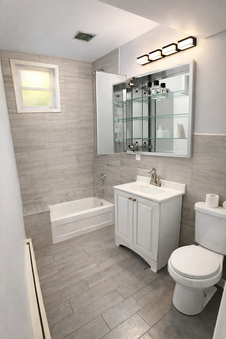 5518 West Melrose Street, Unit G Chicago, IL 60641 - Photo 6 of 8 a bathroom with a toilet a sink a mirror and bathtub