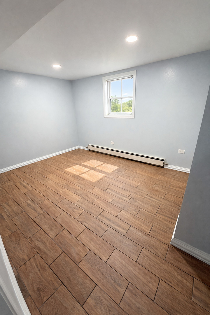 5518 West Melrose Street, Unit G Chicago, IL 60641 - Photo 8 of 8 an empty room with a empty space and window