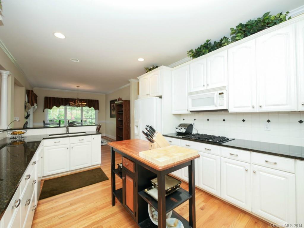 914 Haddonfield Drive, Unit 10 Fort Mill, SC 29708 - Photo 13 of 24 a kitchen with stainless steel appliances granite countertop a stove a sink dishwasher and a refrigerator with white cabinets