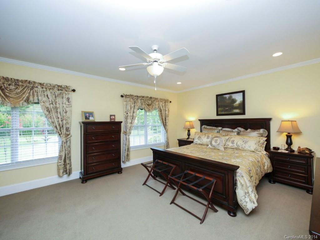 914 Haddonfield Drive, Unit 10 Fort Mill, SC 29708 - Photo 16 of 24 a bedroom with a bed and a chandelier