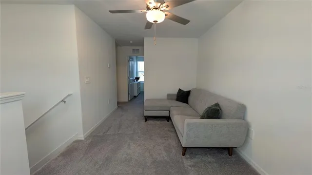 a bedroom with a bed a chandelier and a window