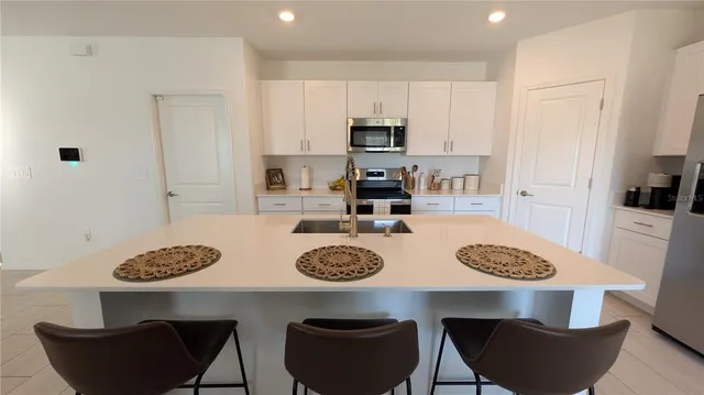 a view of a hallway with wooden floor and a door